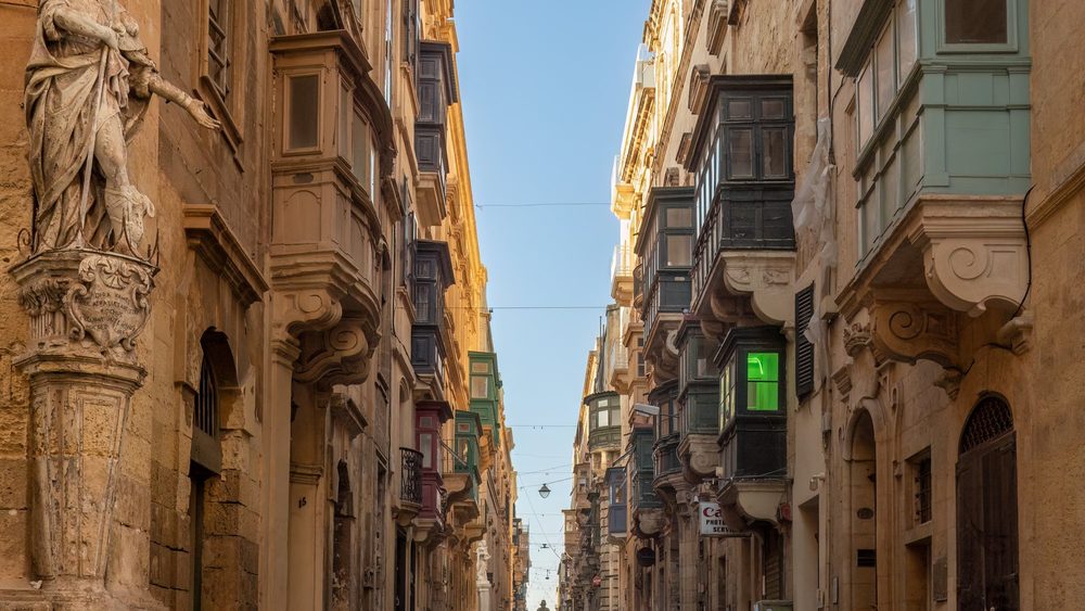 Narrow Saint Christopher Street in Valletta with wooden balconies