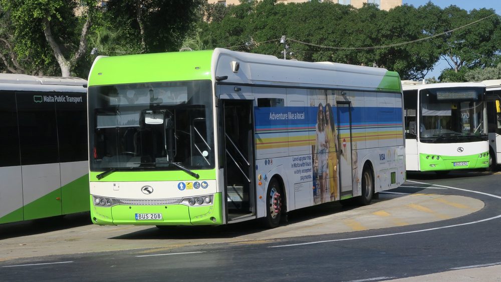 Green and white Malta Public Transport bus at a stop
