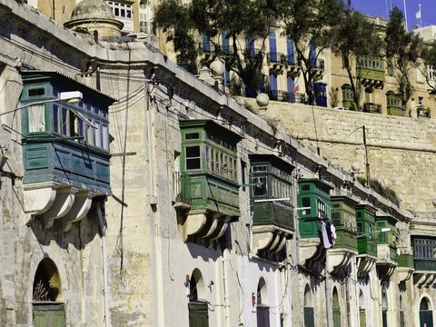 Traditional green wooden Maltese balconies on a Valletta street