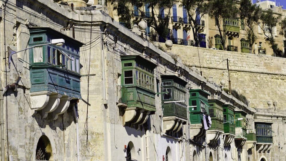Traditional green wooden Maltese balconies on a Valletta street