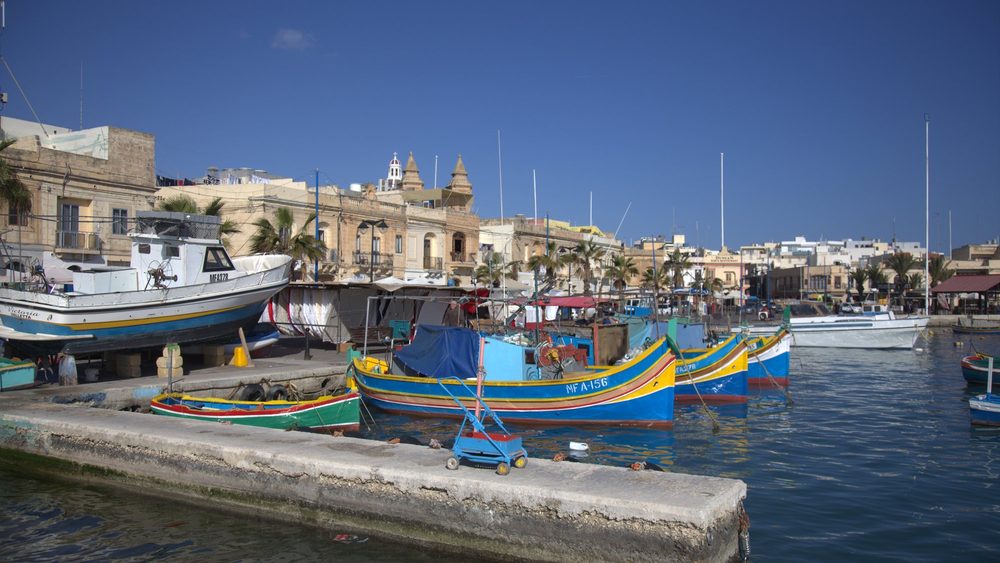 Colorful luzzu fishing boats in Marsaxlokk harbour, Malta
