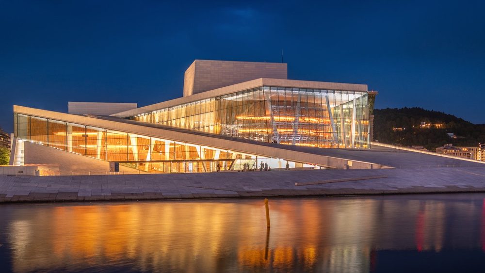 Oslo Opera House glowing at dusk on the Bjorvika waterfront