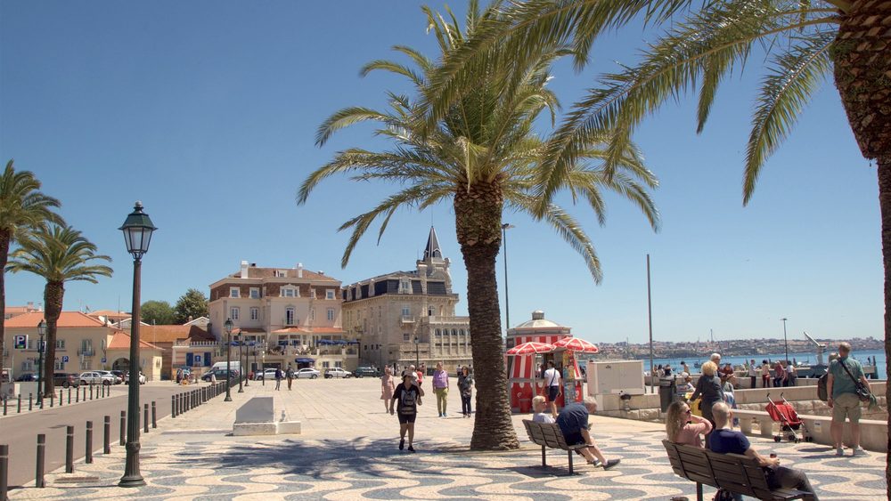Palm-lined waterfront promenade in Cascais