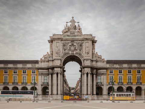 The triumphal Arco da Rua Augusta and the yellow arcades of Praca do Comercio in Lisbon