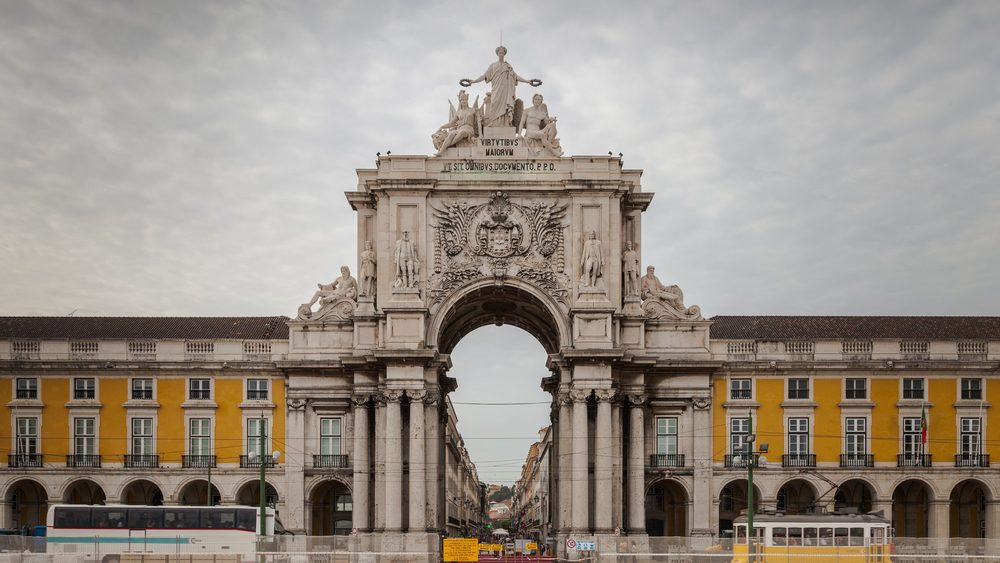 The triumphal Arco da Rua Augusta and the yellow arcades of Praca do Comercio in Lisbon