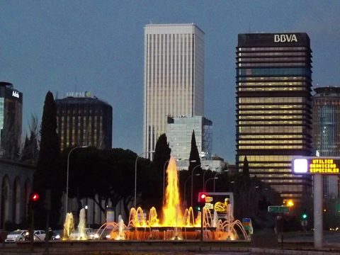 AZCA business district towers and fountain in Madrid at night