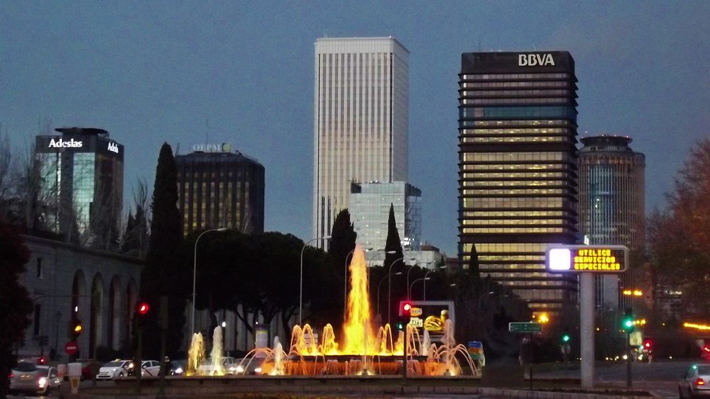 AZCA business district towers and fountain in Madrid at night