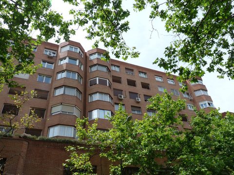 Residential apartment block with trees on a Madrid street