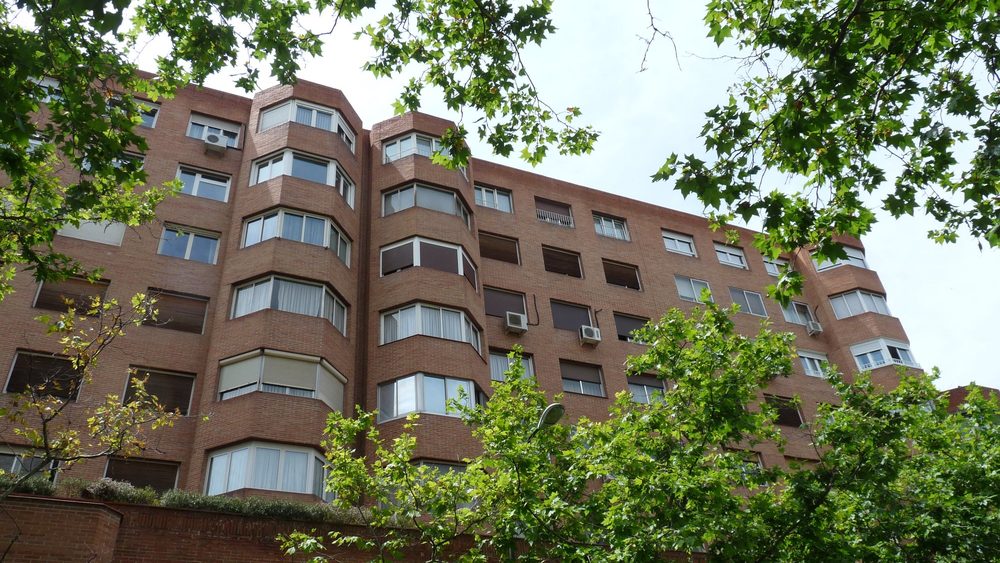 Residential apartment block with trees on a Madrid street