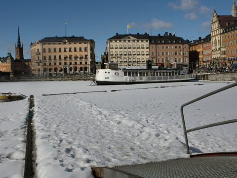 Stockholm old town buildings across the frozen water in winter
