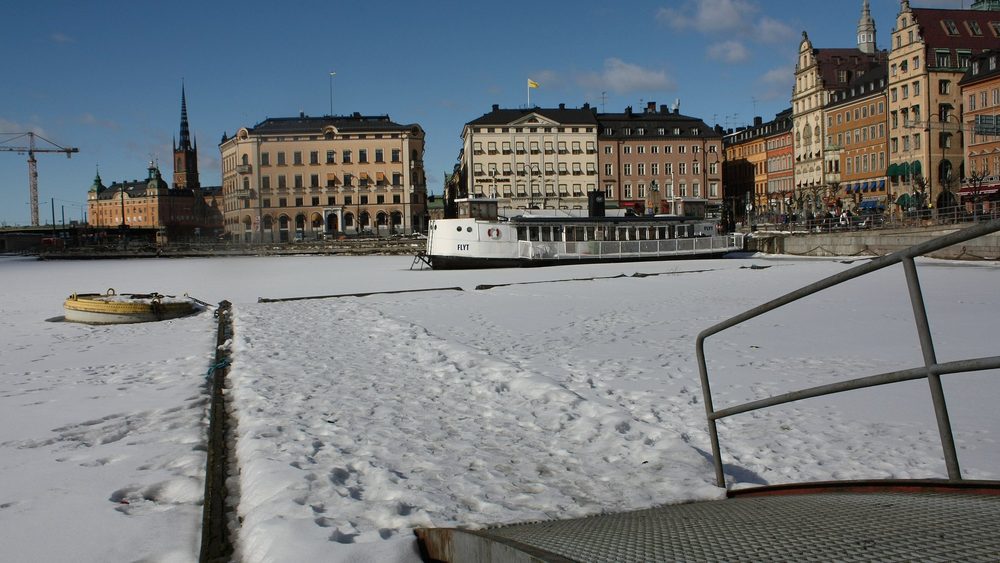 Stockholm old town buildings across the frozen water in winter