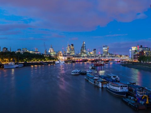 London skyline and the Thames seen from Waterloo Bridge at dusk, United Kingdom