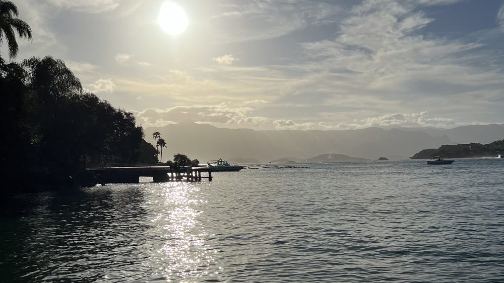 Low sun over a bay, with an island in silhouette