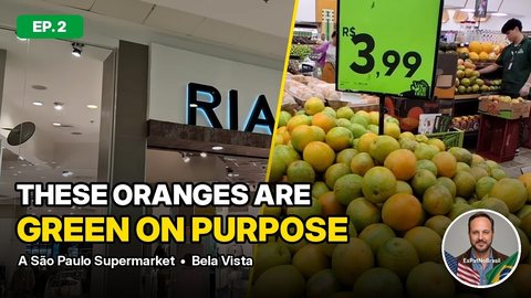 YouTube thumbnail for episode 2: a supermarket entrance and a pile of oranges under a R$3,99 price sign, with the title text “These oranges are green on purpose”